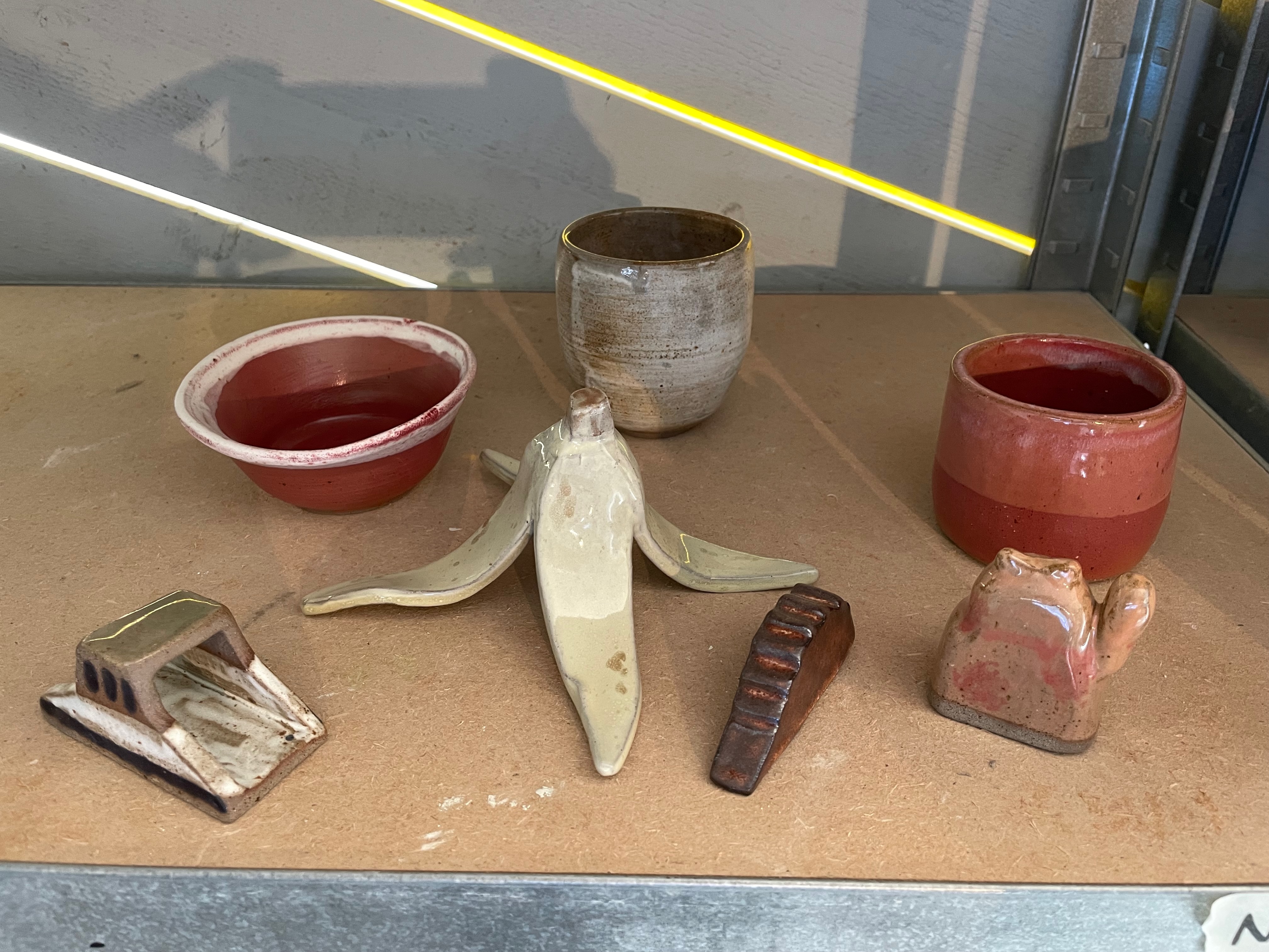 Ceramic bowls, cups, and a banana peel