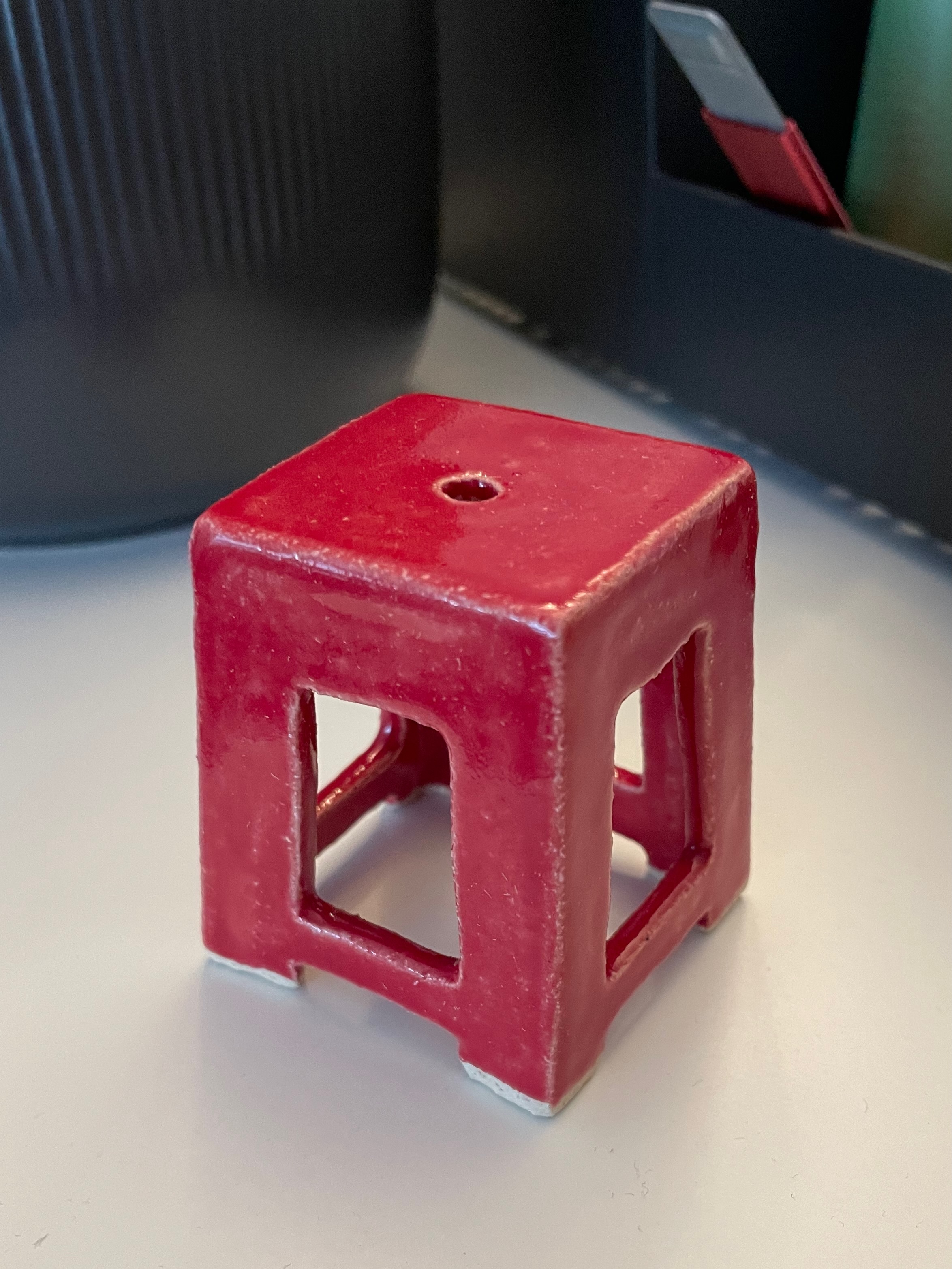 Tiny red ceramic stool